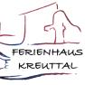 Logo of Ferienhaus Kreuttal with wine bottle, grapes and house outline.