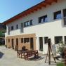 Courtyard with modern buildings and wooden outdoor furniture.