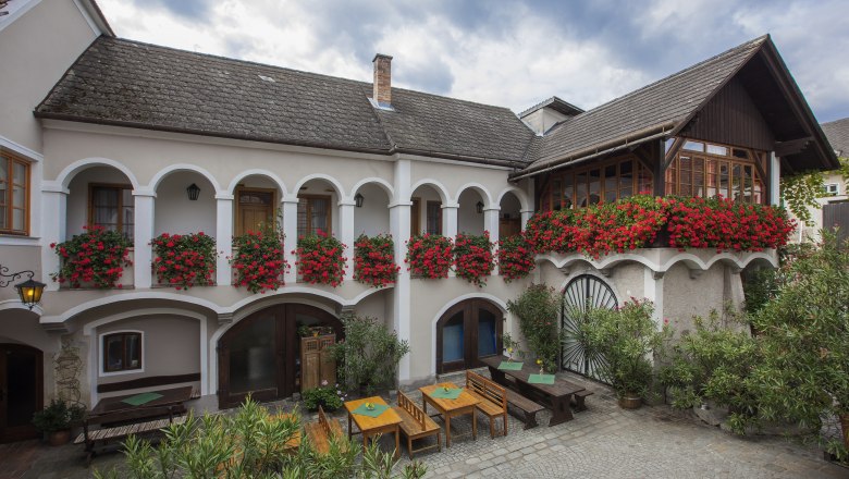 Traditional building with arcades and flower boxes.