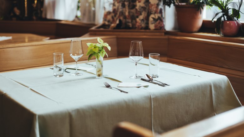 Elegant table in a restaurant set with glasses and cutlery.