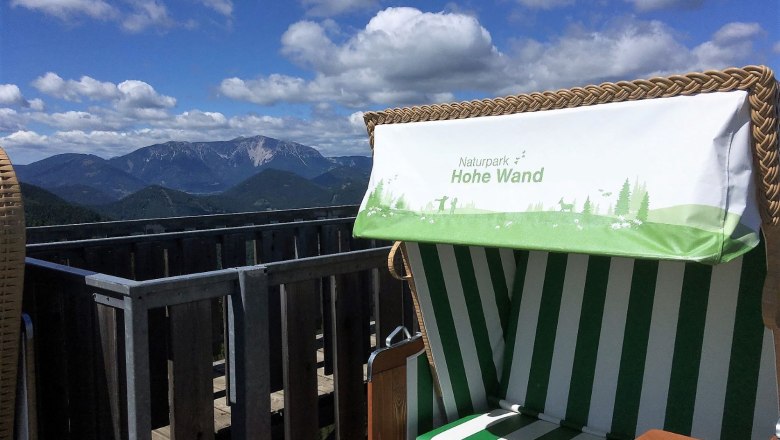 View of the Schneeberg from the Hohe Wand Nature Park with a beach chair in the foreground.