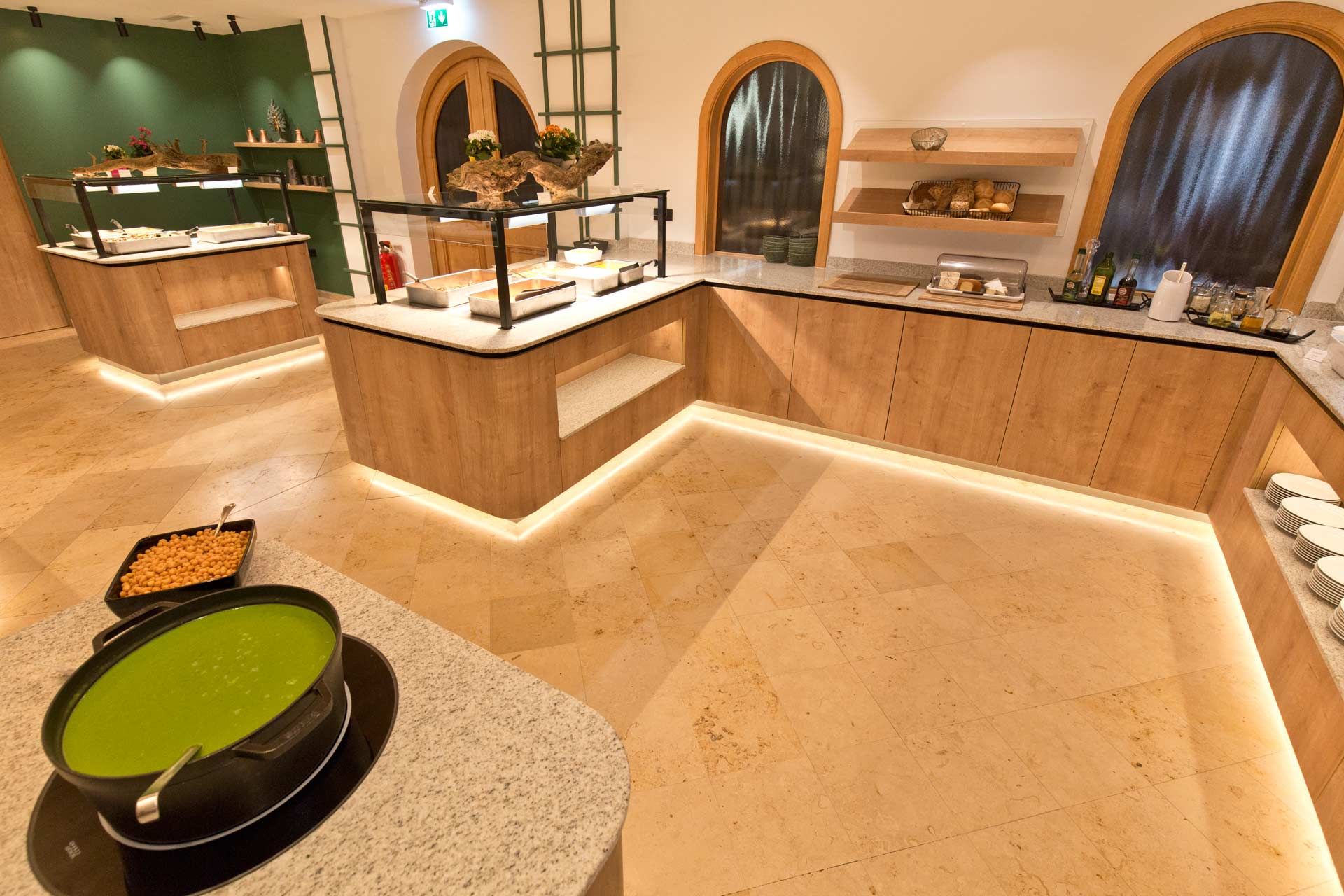 Modern buffet area with wood paneling and illuminated counters.