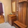 Modern entrance area with wooden furniture, mirror and decoration.