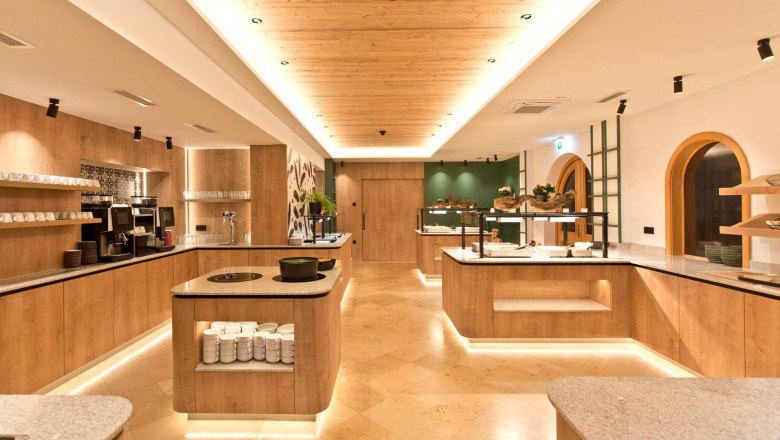 Modern buffet area with wood paneling and lighting.