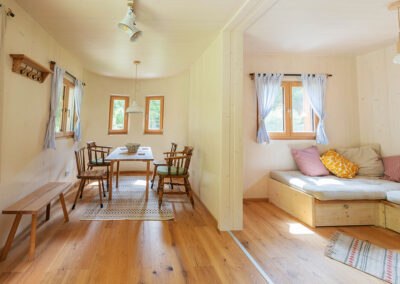 Interior view of a cozy modular house with dining area and sitting area.