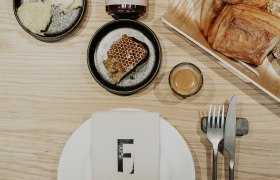 Breakfast pastries, honey, place setting