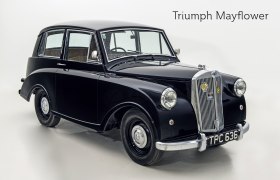 A black Triumph Mayflower vintage car against a white background.