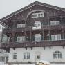 A large, traditional building in the snow, labeled 'Schneeberghof'.