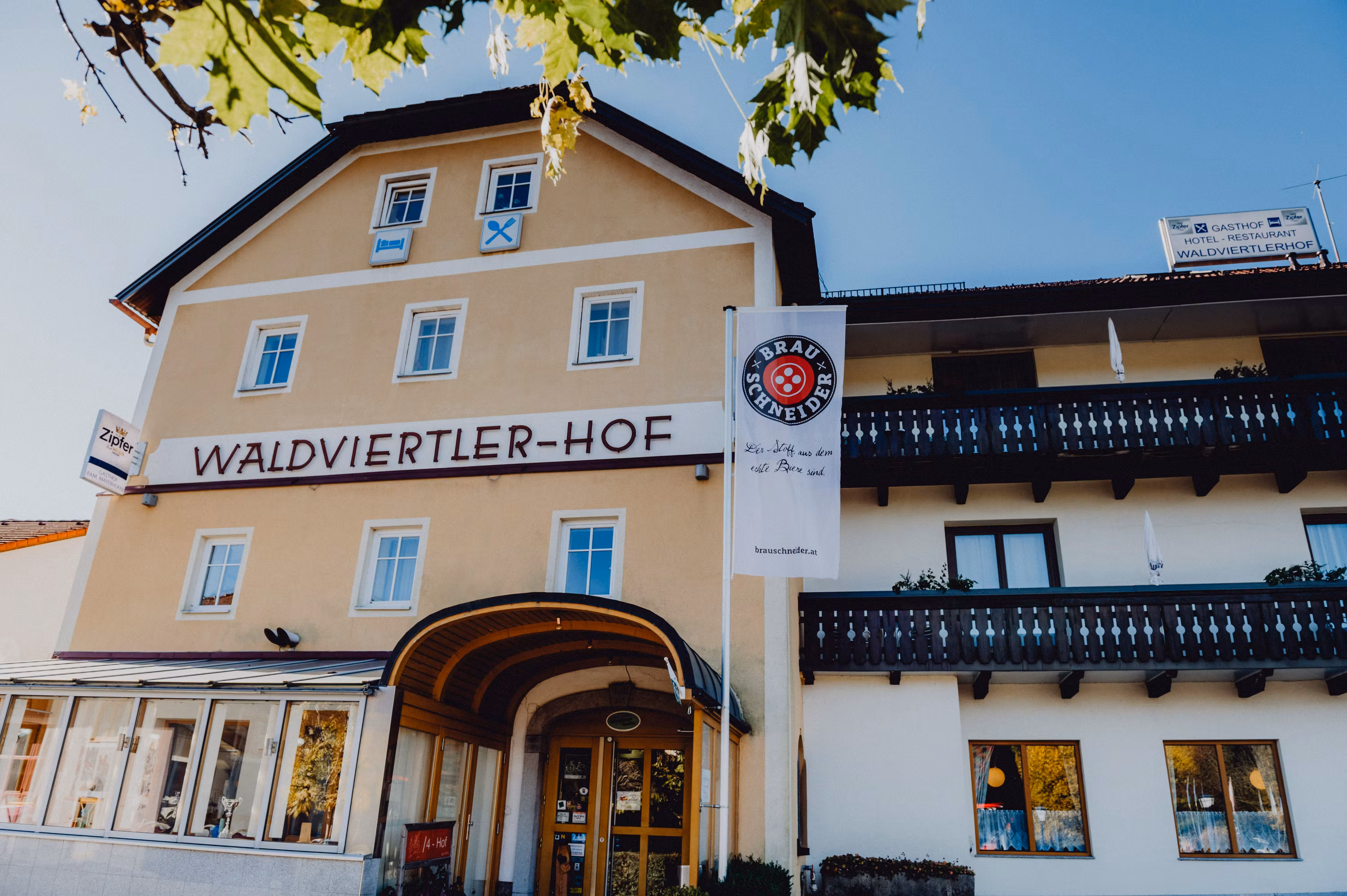 Exterior view of the Waldviertler-Hof with balconies and advertising banner.