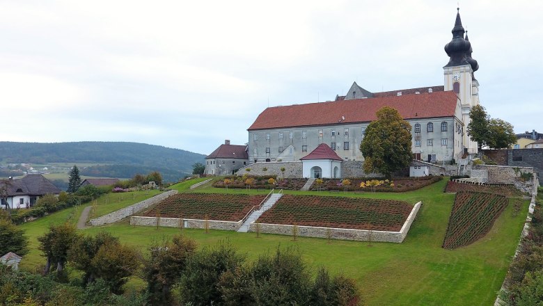Landscape with church and gardens on a hill.
