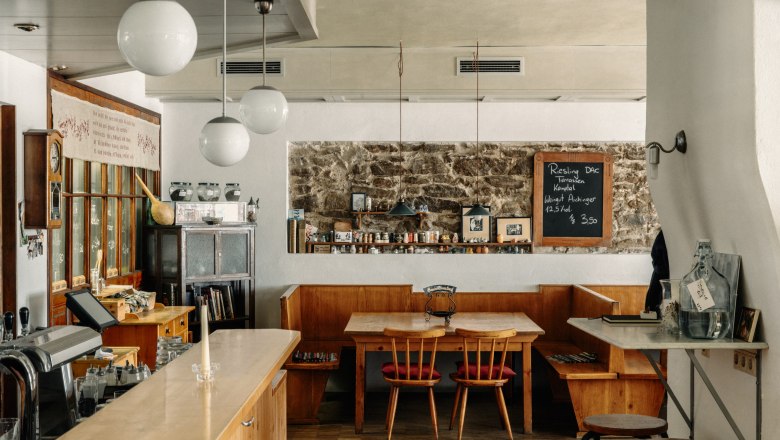 Cozy café with wooden furniture and chalkboard on the wall.