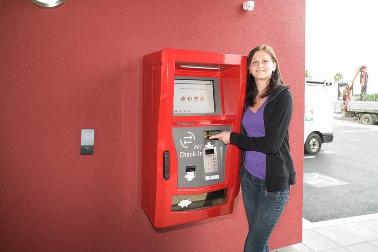 Woman uses check-in machine at the Cleverhotel Herzogenburg.