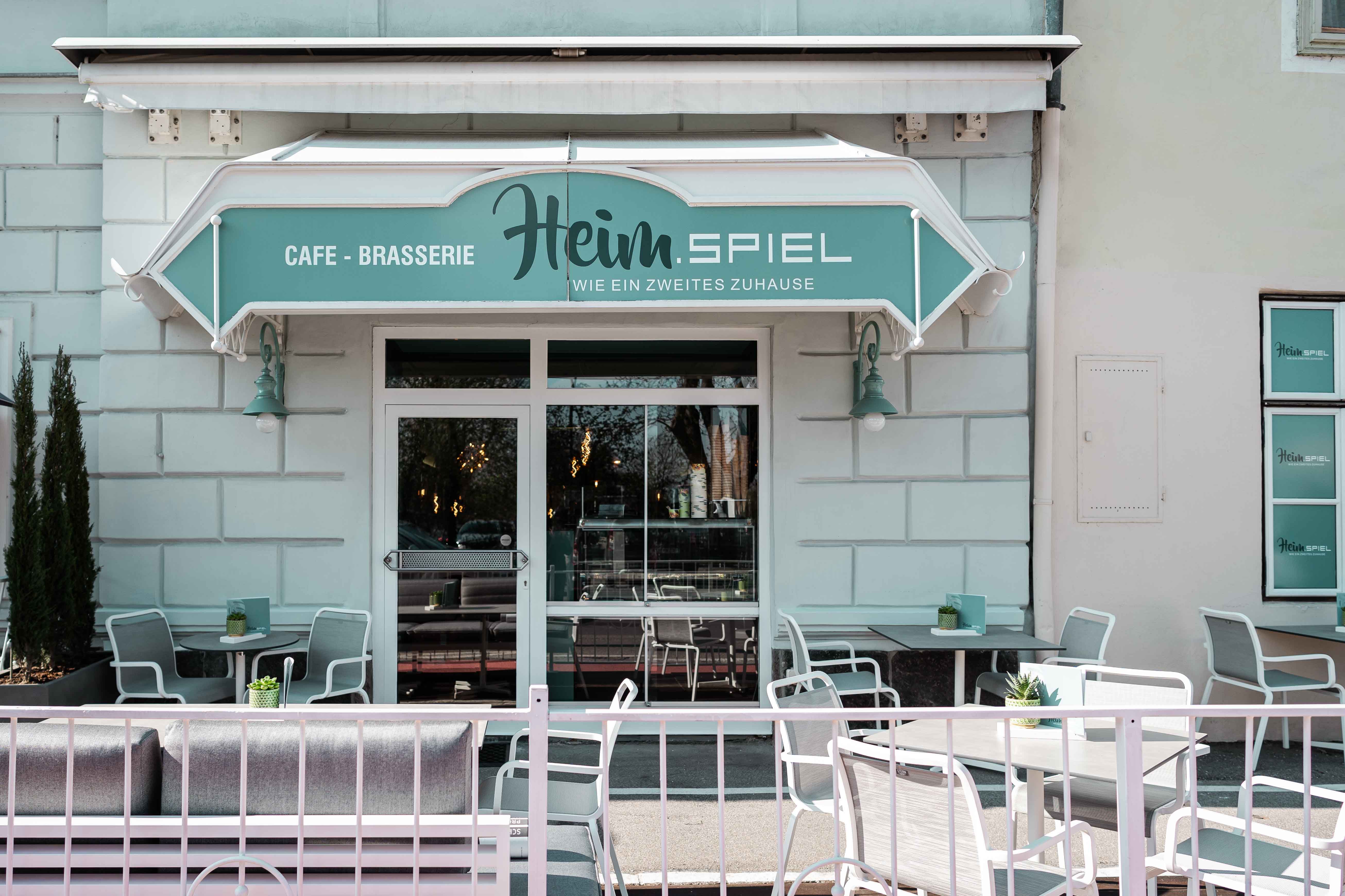 Exterior view of a café with terrace and seating.