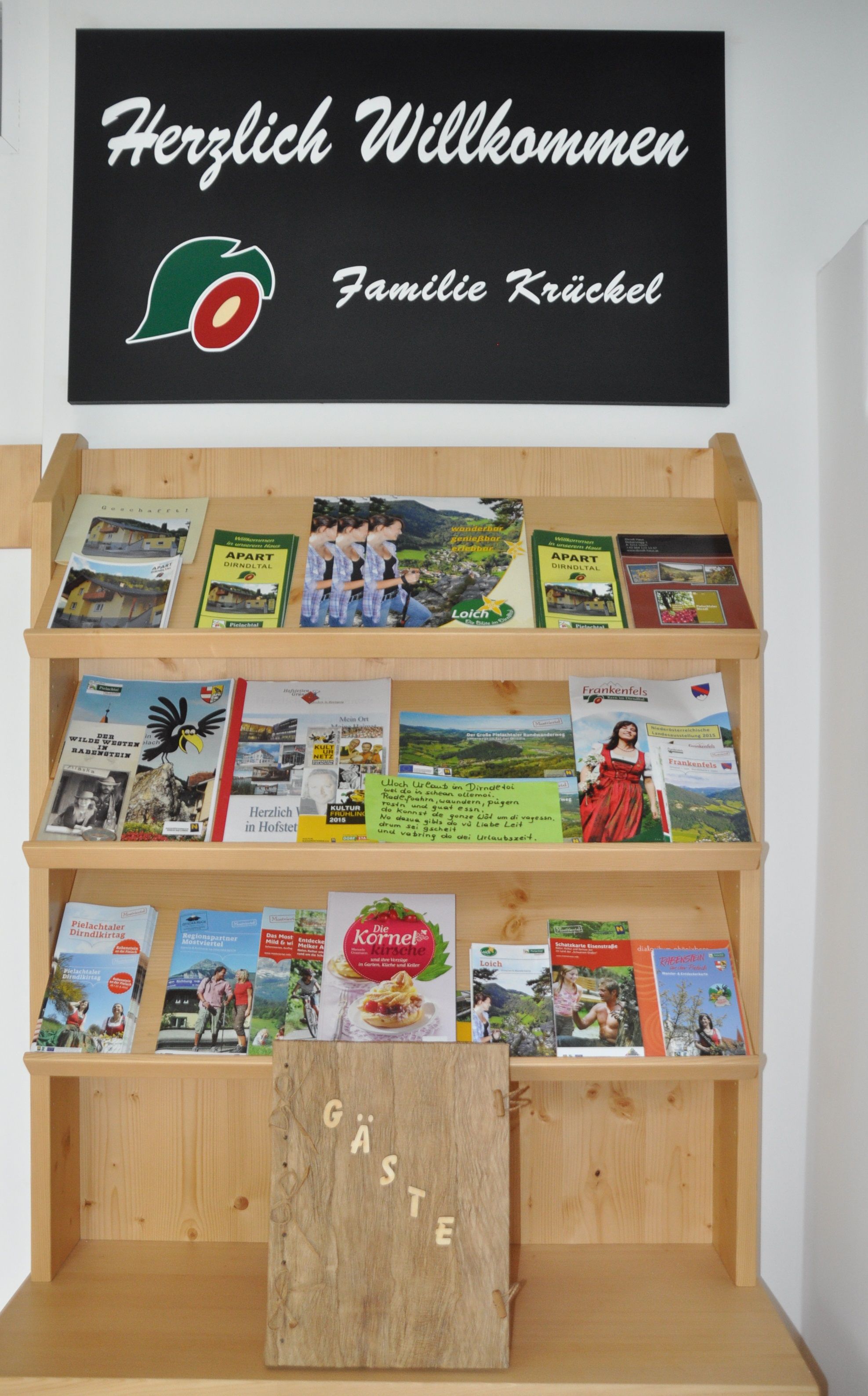 A shelf with brochures and a sign saying 'Welcome Krückel family'.