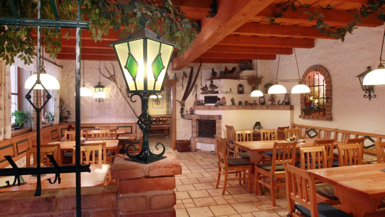 Cozy interior of a winery with wooden furniture and decorative lamps.