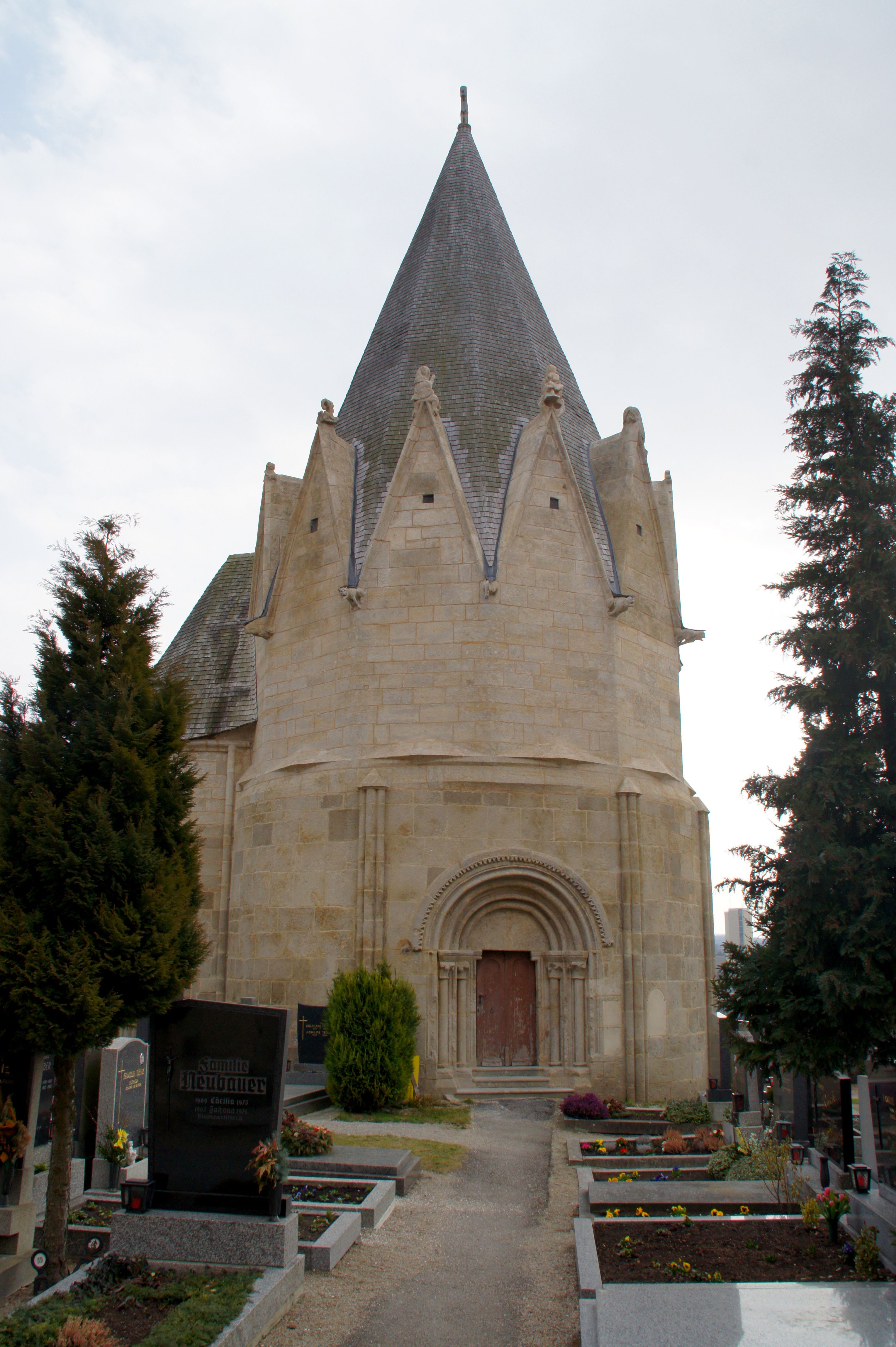 Karner Pulkau, a historic building with a pointed roof, surrounded by a cemetery.