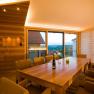 Modern tasting room with wooden table, chairs and panoramic window overlooking the countryside.