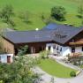 Aerial view of a farm with a green roof and floral decorations.
