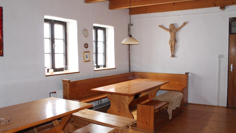 Rustic room with wooden furniture, wooden beamed ceiling and wall decoration.