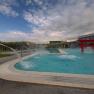 Outdoor pool at Hotel & Spa Linsberg Asia with waterspouts and red torii.