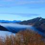View from a mountain of mist-covered valleys and wooded hills.