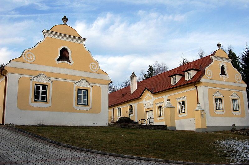 Historic Krumbach vicarage with yellow facades and red roofs.