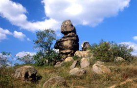 Kogelstein rock formation under a blue sky with clouds.