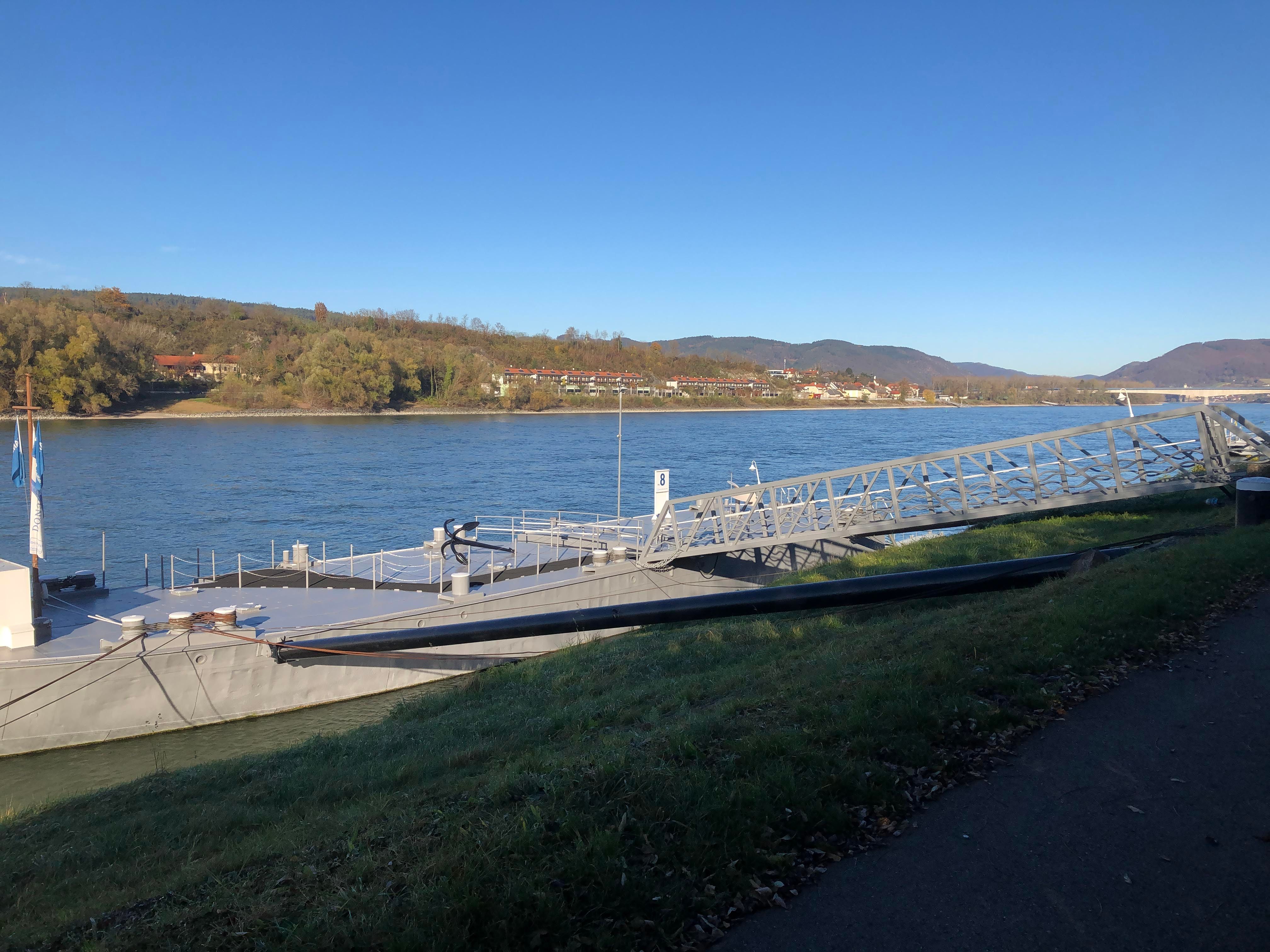 Mooring on the Danube with bridge and river in the background.