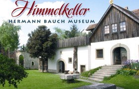 Exterior view of the Hermann Bauch Museum with garden and buildings.