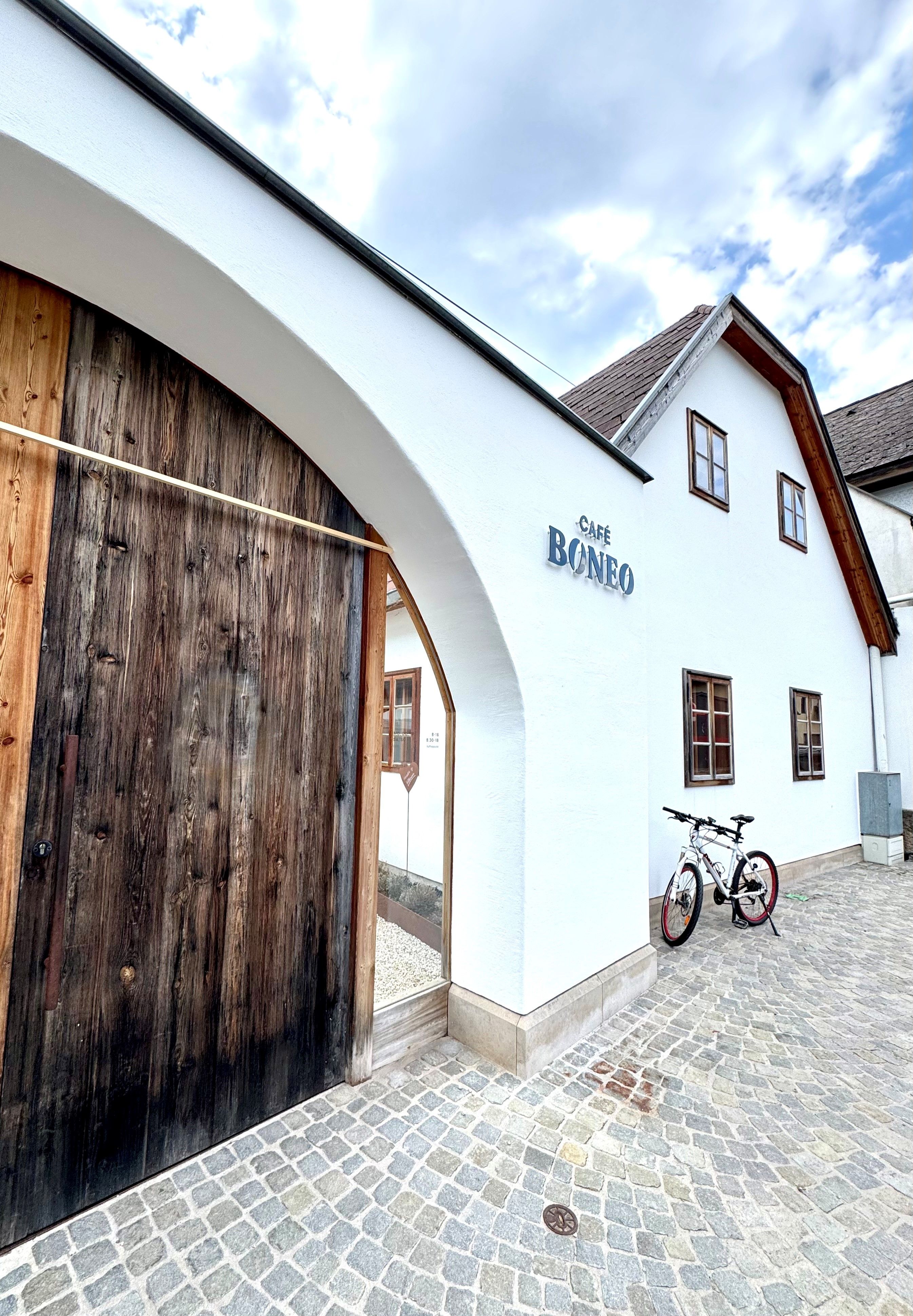 Entrance to Café Boneo in Pernitz with a bicycle in front of it.
