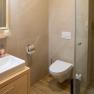 Modern bathroom with washbasin, toilet and shower cubicle.