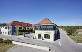 Winzer Krems building with red roofs and blue sky.
