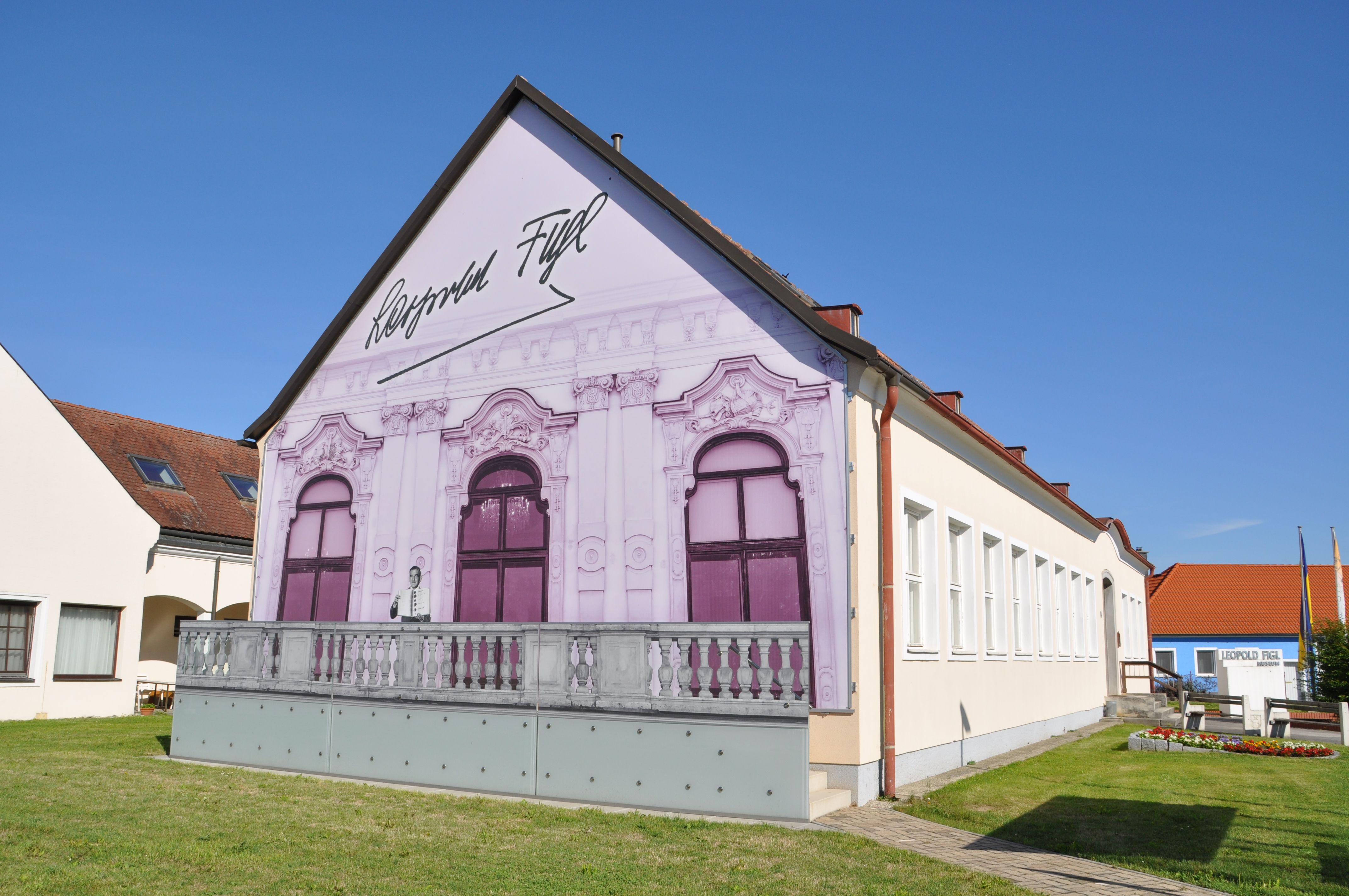 Leopold Figl Museum with painted façade and blue sky.
