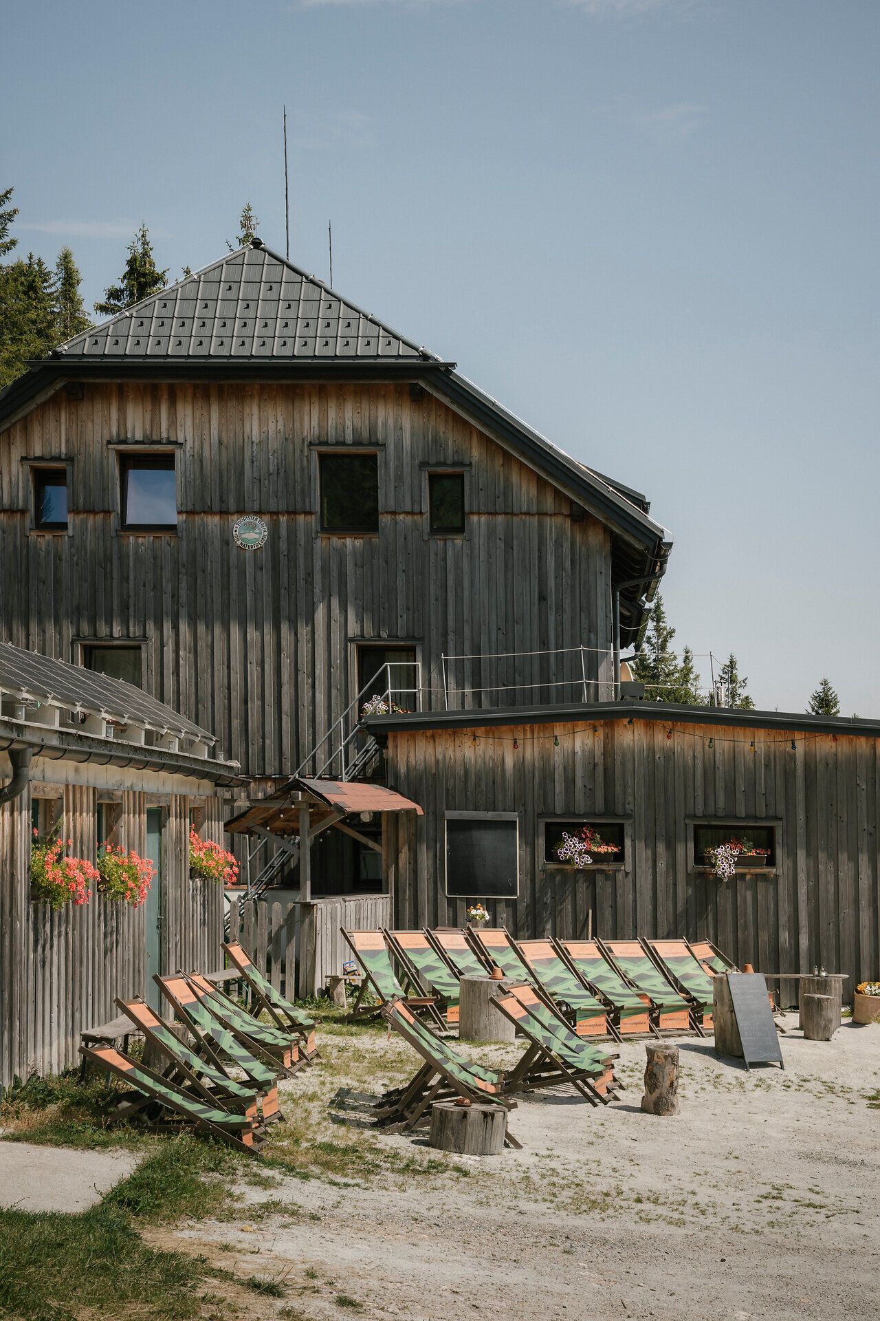 Waxriegelhaus on the Rax, with lounge chairs in front of the traditional wooden building