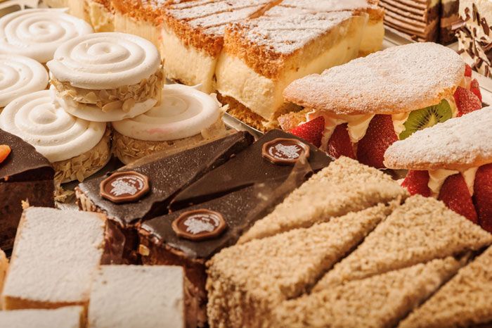 Various cakes and tarts in a patisserie.