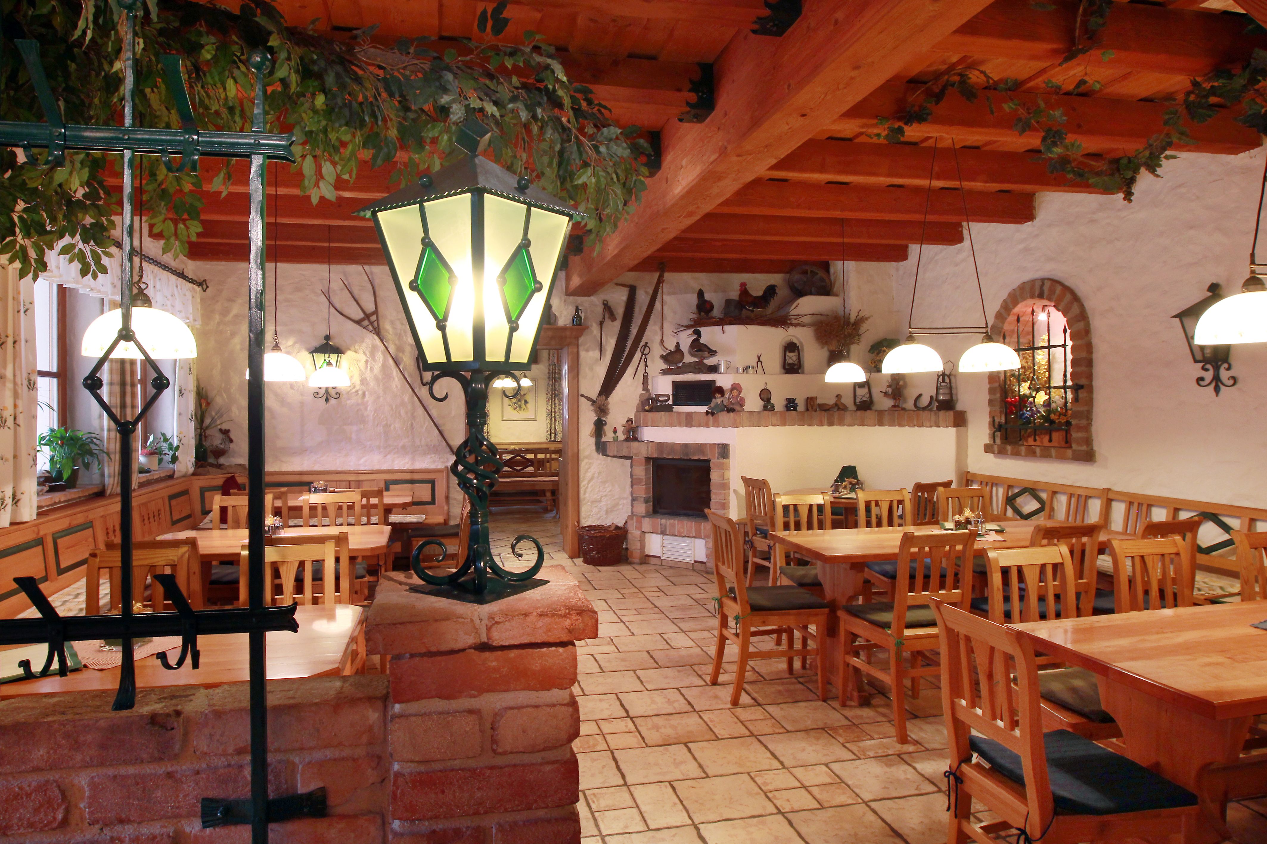 Cozy interior of a winery with wooden furniture and decorative lamps.