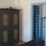 Interior with painted cupboard and blue tiled bathroom.