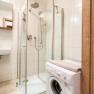 Modern bathroom with shower and washing machine.
