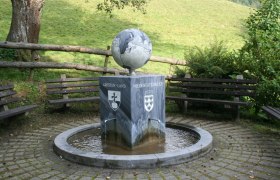 Fountain with globe and coat of arms in Gresten-Land, Lower Austria.