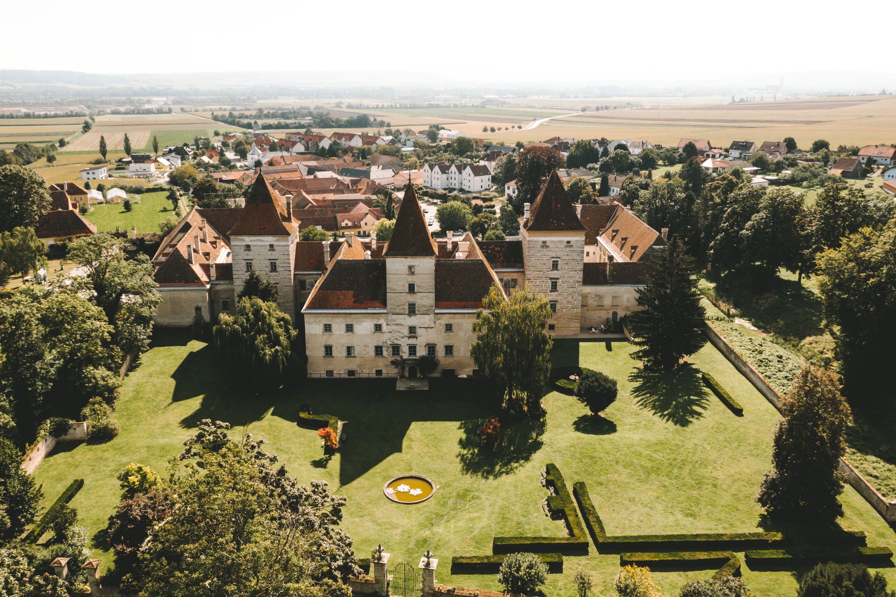 Aerial view of Walpersdorf Castle with surrounding landscape.