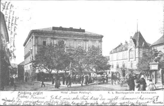 Historical view of the Hotel Stadt M&ouml;dling with people and carriages on the street.