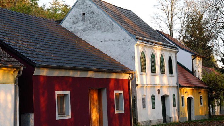 Traditional wine cellars in the Absberg wine cellar lane with colorful facades and green shutters.