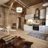 Cozy apartment with wooden walls, modern kitchen, dining table and TV. Rustic style with carpet and wooden furniture.