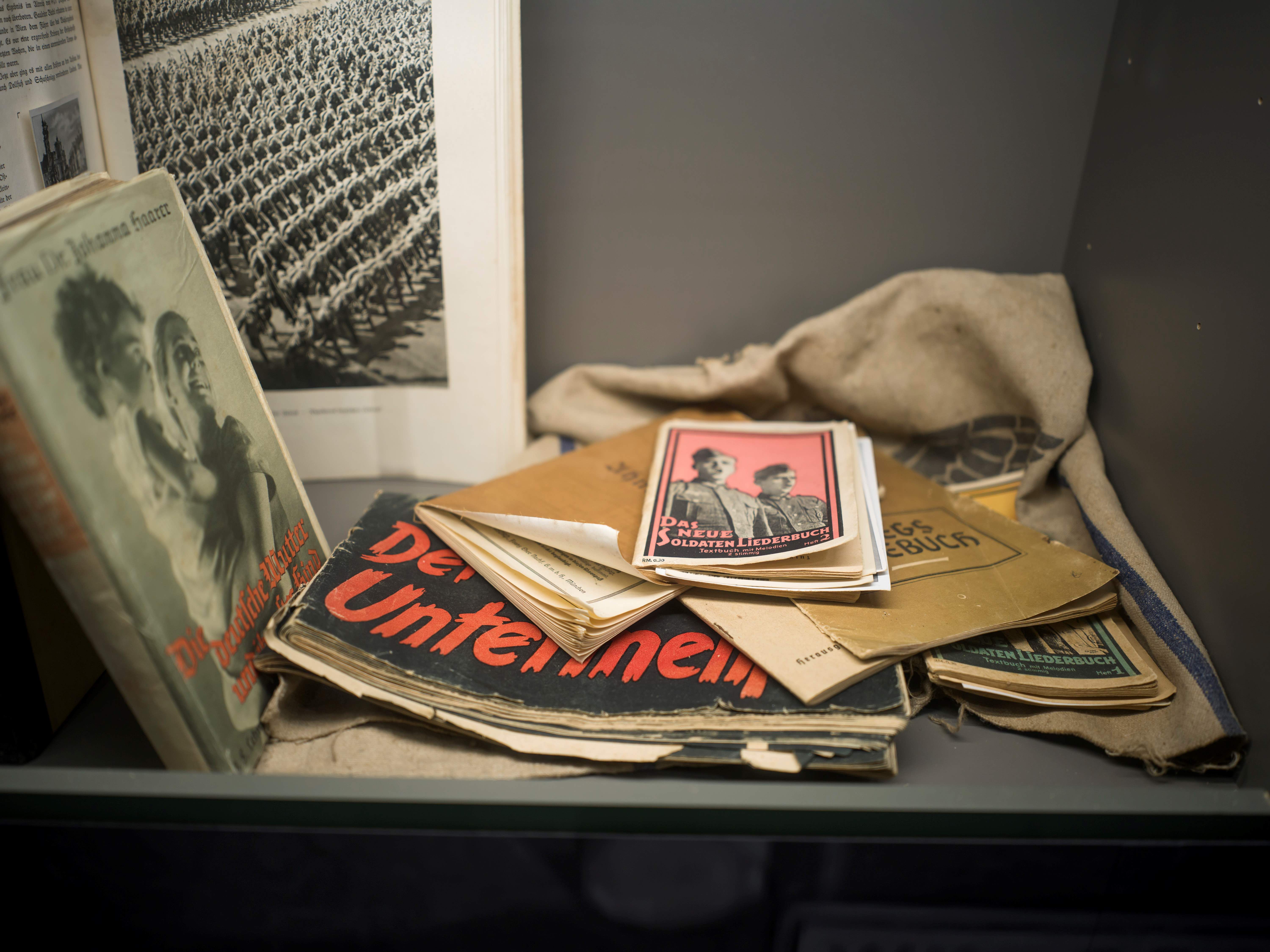 Historical books and documents in a display case in the Erlauf Peace Museum.