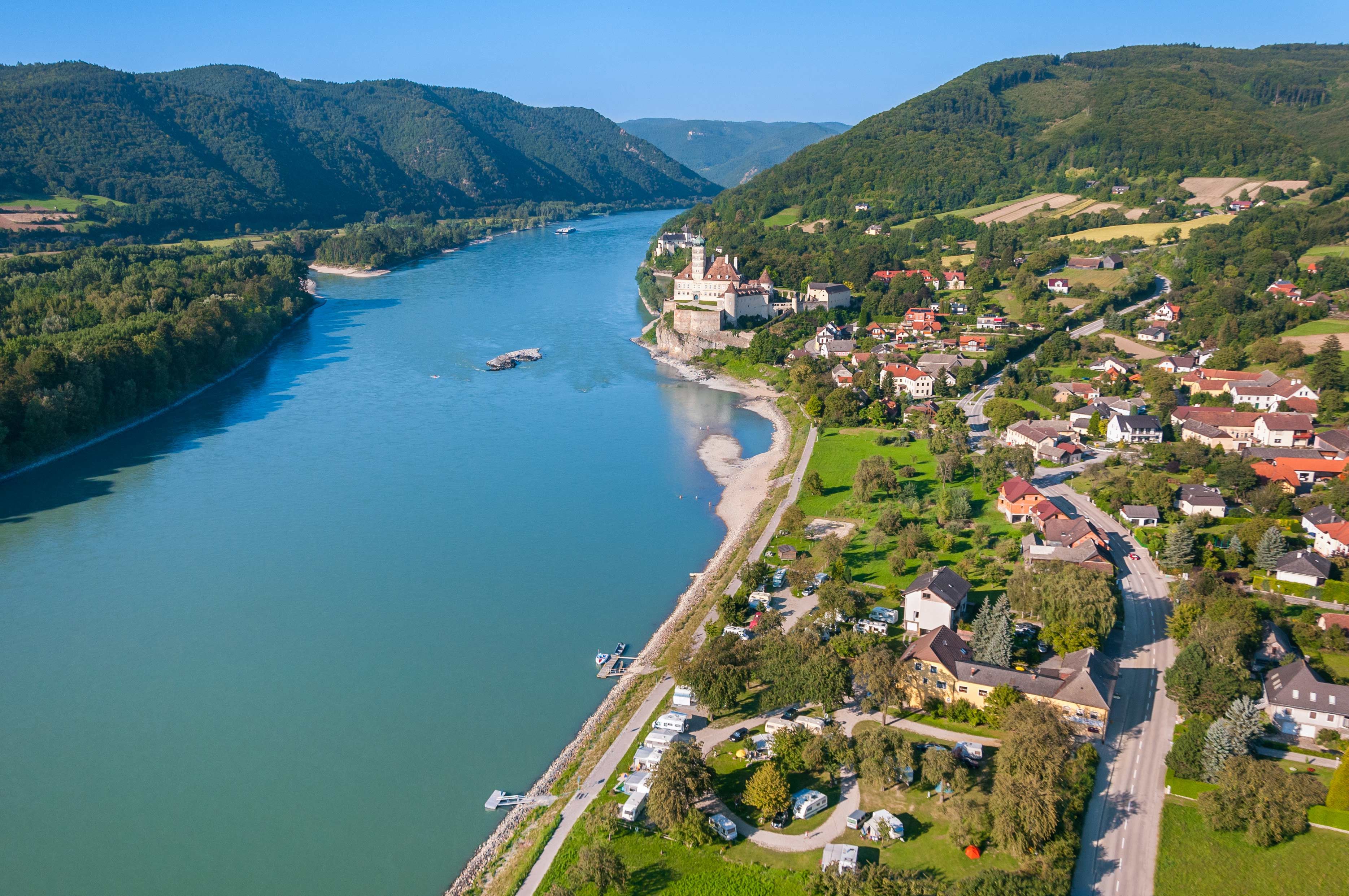 Aerial view of Schönbühel-Aggsbach on the Danube with castle and surrounding landscape.