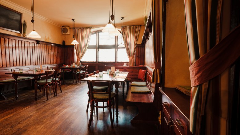 Cozy restaurant with wooden furniture and warm light.