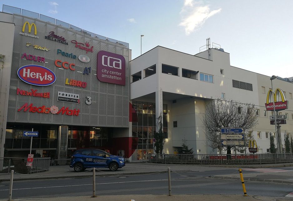 Shopping center City Center Amstetten with logos of stores and McDonald's sign.