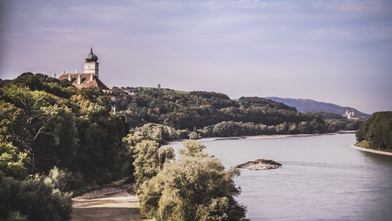 View of Sch&ouml;nb&uuml;hel Castle and the Danube with wooded banks.