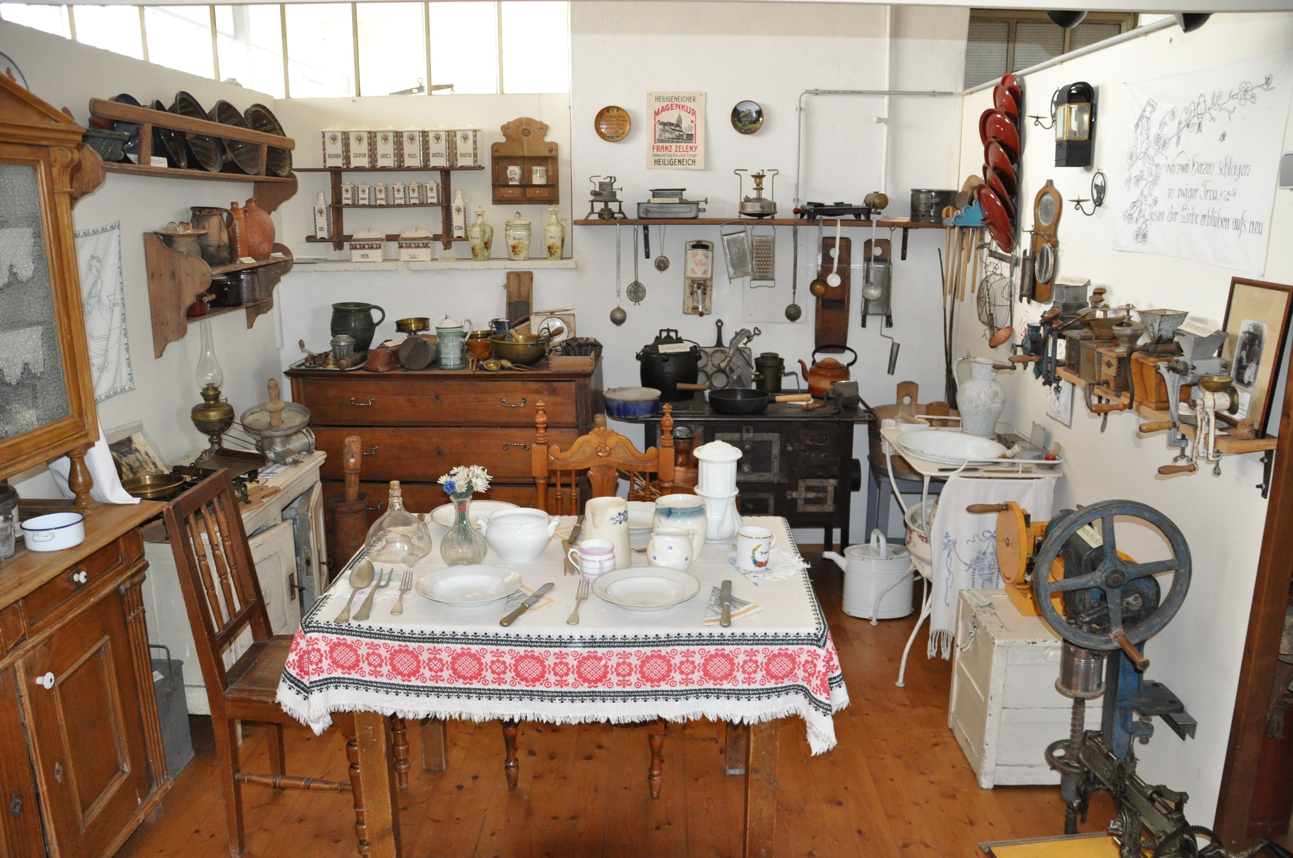A room in the Michelhausen local history museum with antique kitchen utensils and furniture.