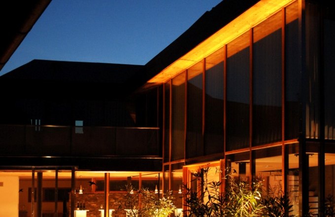 Illuminated inner courtyard of a modern building at night.